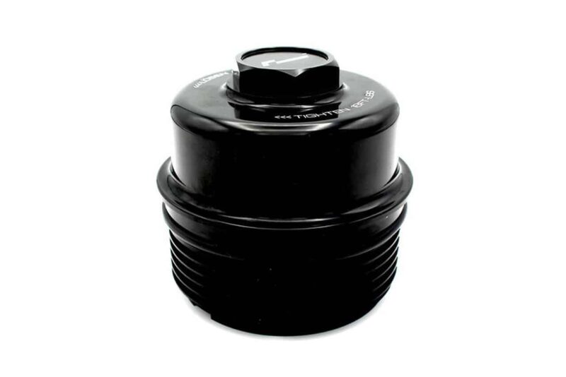 Close-up of a black cylindrical camera lens accessory with a ridged, threaded base and a top dial.