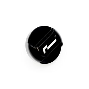 Close-up of a glossy black circular object with white diagonal stripes on a white background.