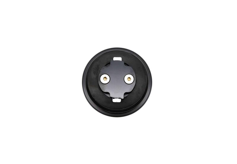 Close-up of a round black electrical receptacle with two gold-colored contacts inside a circular housing.
