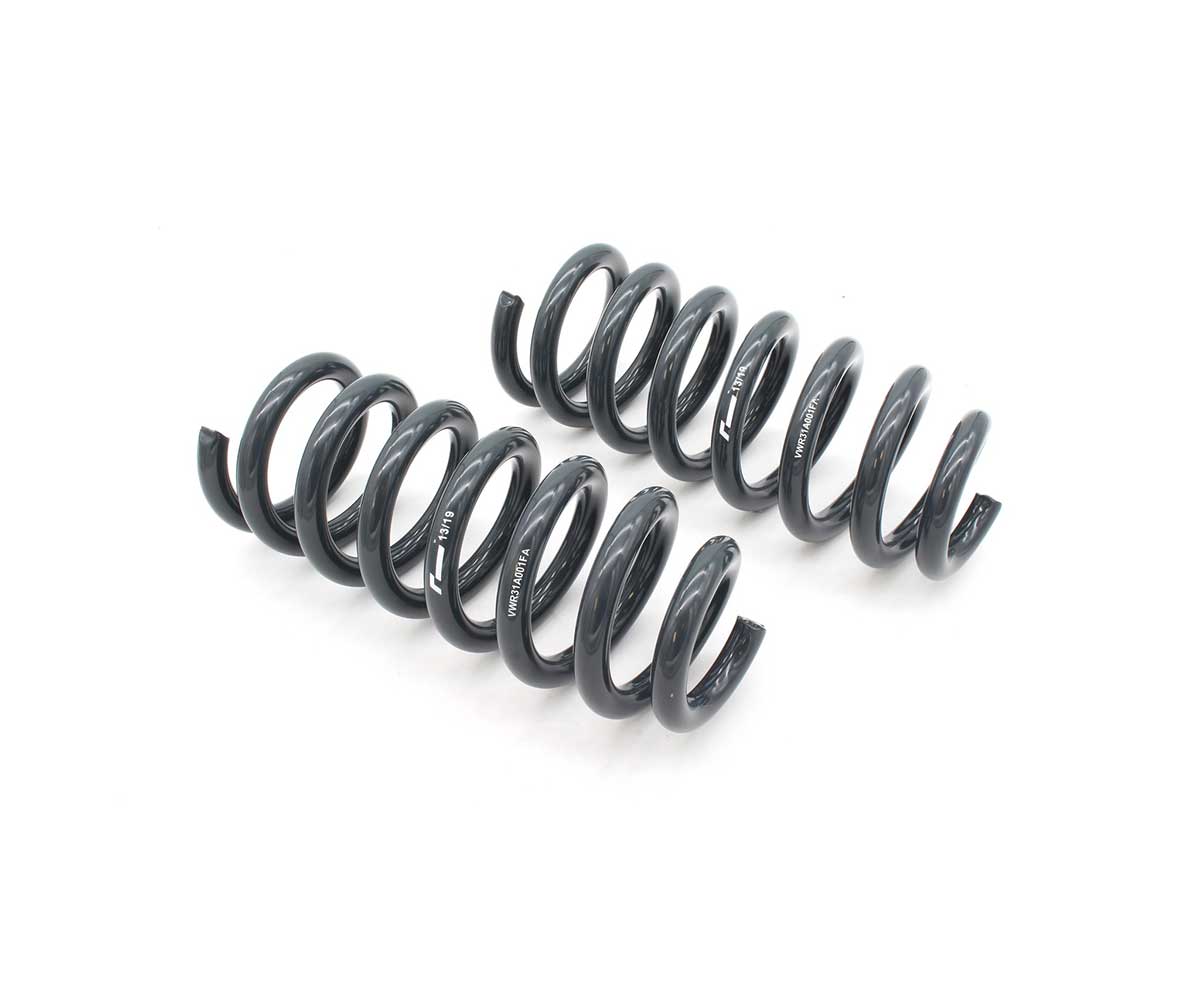 53272536009_8877297ae3_k-1jpg - OPSHOLDERS Pair of dark gray automotive coil springs laid out on a white background, likely suspension components