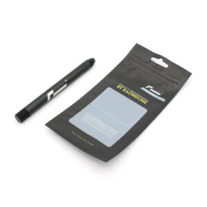53469880674_09b0d2c64e_k-1jpg - OPSHOLDERS Black pen-shaped tool placed beside a matte black resealable package with RacingLine branding and a hang hole.