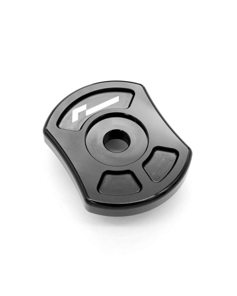 Close-up of a black ergonomic device with a central round knob and surrounding buttons, logo visible.]