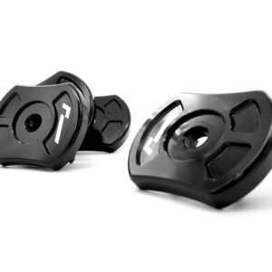 Close-up of black metal locking collars with a central hole and white markings, scattered on a white background; likely bicycle or mechanical components used to secure parts.