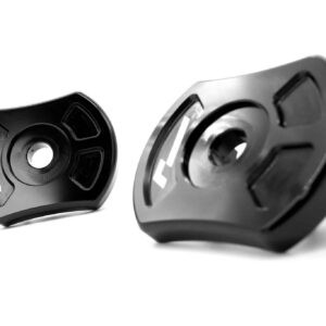 Close-up of two glossy black lens caps marked L and R on a white background, facing each other.