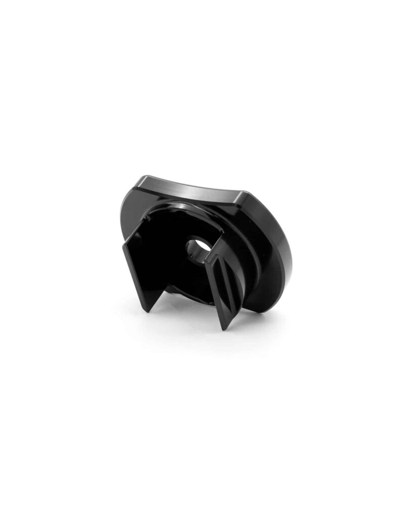 Close-up of a black glossy plastic mechanical part with curved edges and a central hole on a white background.