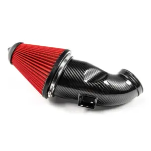Red cone air filter mounted to a carbon-fiber performance intake pipe, close-up view