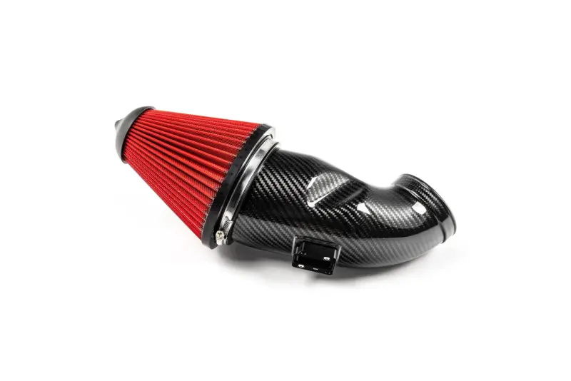 Red cone air filter mounted to a carbon-fiber performance intake pipe, close-up view