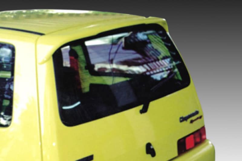 A-103_1jpg - OPSHOLDERS Rear view of a yellow van with a cracked rear window and visible damage from an impact.