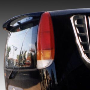 Rear-left close-up of a black SUV showing a red taillight and reflected street scene in the rear window.