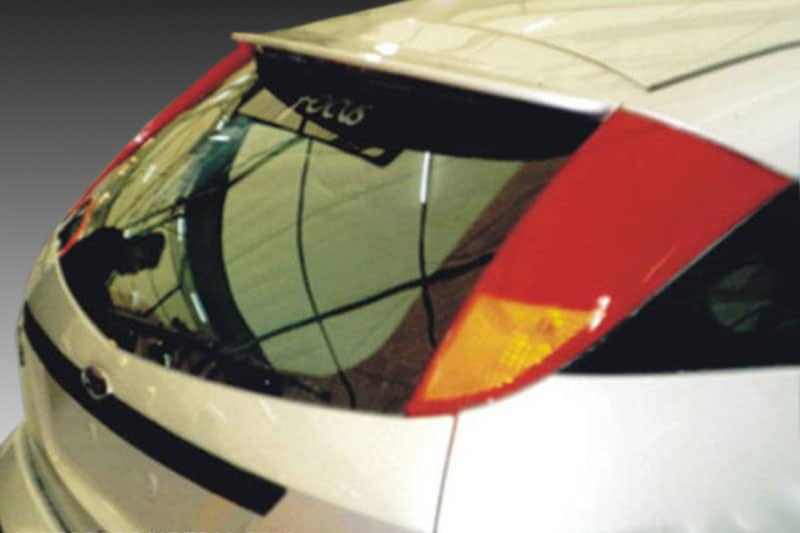 A-156_1jpg - OPSHOLDERS Close-up of a white hatchback rear, showing the curved rear window and orange taillight.
