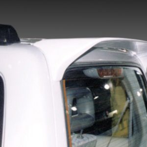 A-157_2jpg - OPSHOLDERS Close-up of a white van's rear corner showing a roof spoiler and the passenger-side window