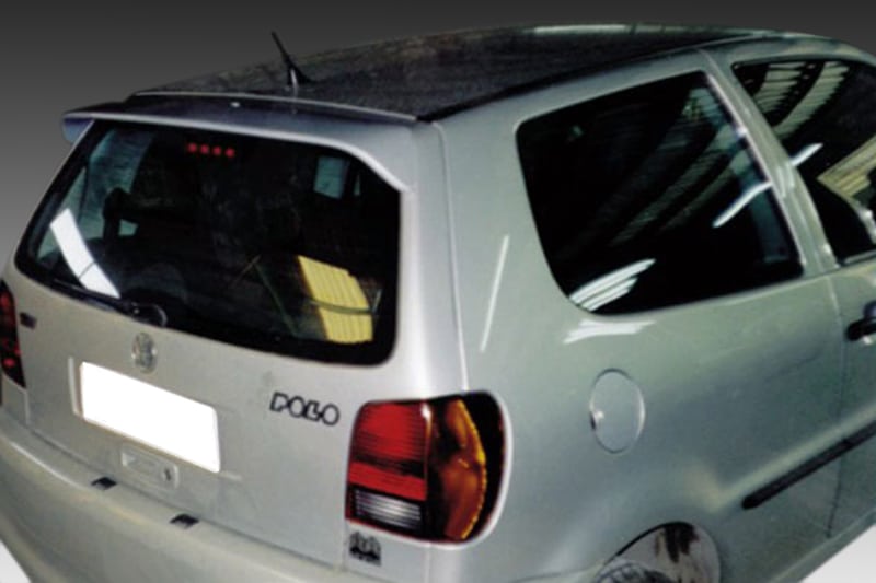 A-160_1jpg - OPSHOLDERS Silver hatchback car seen from the rear three-quarter angle, showing taillights, rear window, and side panel with a visible badge on the left side of the tailgate.