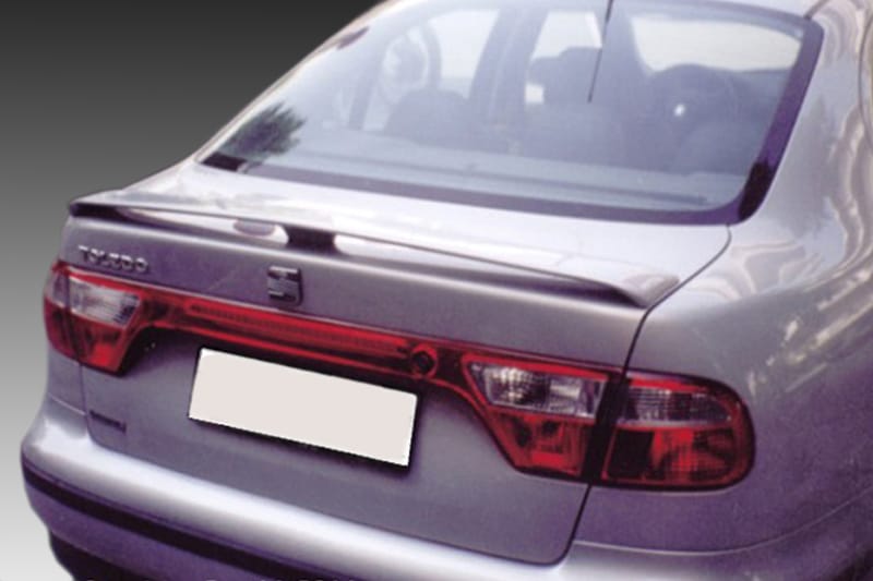 A-165_1jpg - OPSHOLDERS Rear view of a silver sedan with a blurred license plate and red tail lights.