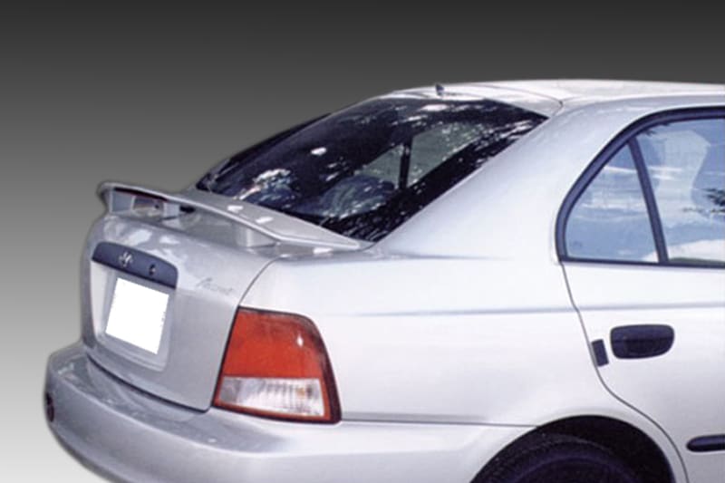 A-170_1jpg - OPSHOLDERS Rear view of a white sedan with a spoiler, taillights visible, and a cracked rear windshield/window fading to black background.