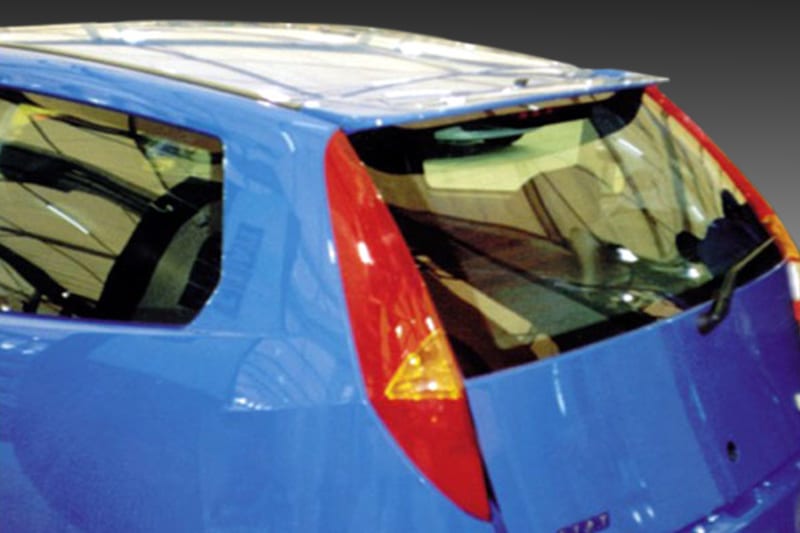 A-173_1jpg - OPSHOLDERS Blue hatchback seen from the rear side with a red taillight and beige interior, interior visible through the windows (car showroom).