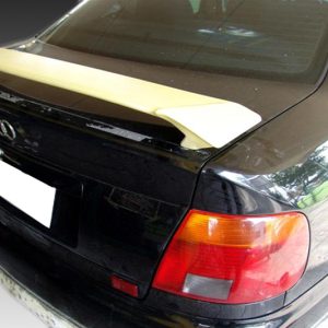 Rear view of a black Audi with a beige spoiler, visible taillights, and a white license plate area.