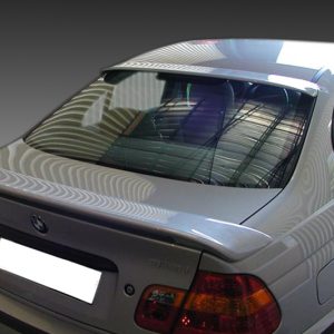 Rear view of a silver BMW 3-series sedan with a small lip spoiler on the trunk, shown at an angle with blurred license plate and taillights visible.