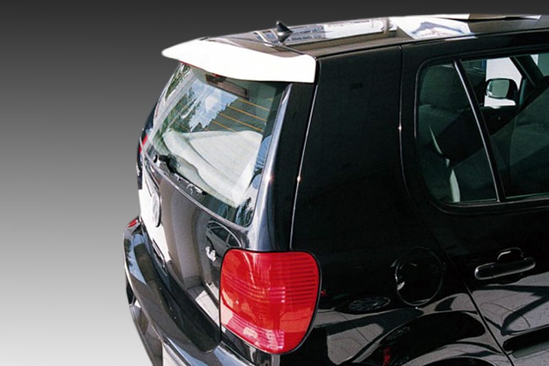 A-195_1jpg - OPSHOLDERS Black SUV rear-quarter view with red taillight, rear window, and small spoiler visible on the hatch edge.