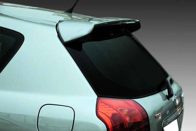 A-219_2jpg - OPSHOLDERS Rear view of a light-blue hatchback with a spoiler and tinted rear window, showing the left taillight and fuel door.