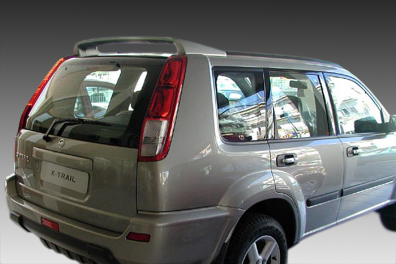 A-220_1jpg - OPSHOLDERS Rear three-quarter view of a silver Nissan X-Trail SUV showing the back and right side doors (urban setting reflected in windows).