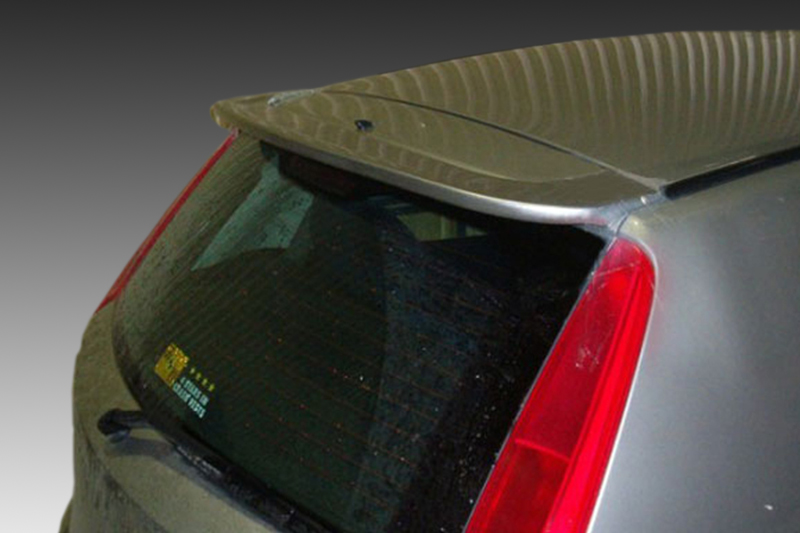 A-243_1jpg - OPSHOLDERS Rear view of a gray hatchback with a large black spoiler mounted at the top of the rear window edge.