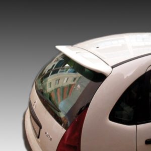 Rear view of a white hatchback car with a spoiler and curved rear window; reflections of buildings are seen in the window.