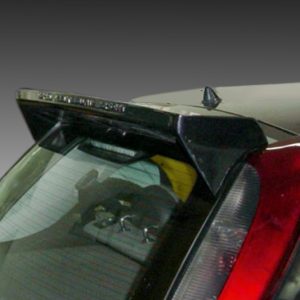 Back of a dark hatchback car showing a small lip spoiler above the rear window, with the red tail light to the right.