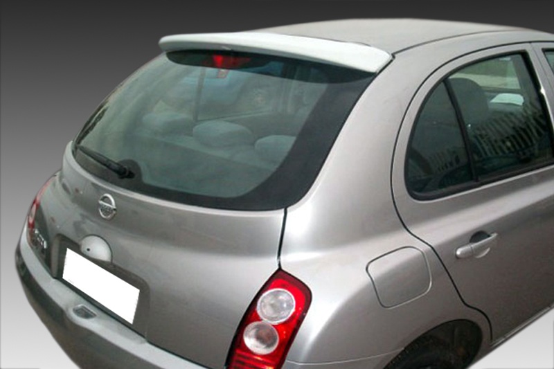 A-254_1jpg - OPSHOLDERS Rear three-quarter view of a silver Nissan hatchback photographed against a gray gradient background.