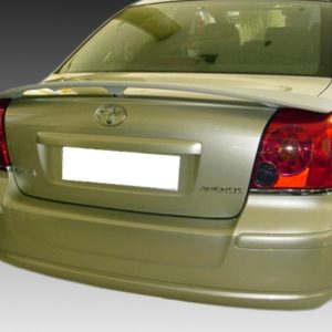 Rear view of a gold Toyota Avensis sedan with the license plate blurred/blocked back plate.