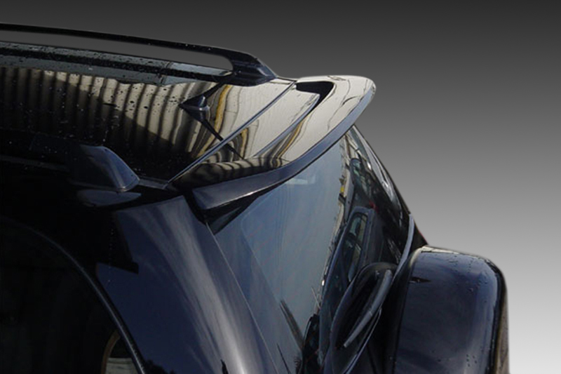 A-270_1jpg - OPSHOLDERS Close-up of a black car's rear spoiler and curved roof with a reflective surface.
