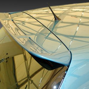 Close-up of a blue car’s rear spoiler and curved glass roof reflecting the interior structure.