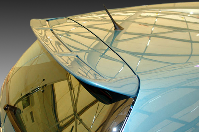 A-271_1jpg - OPSHOLDERS Close-up of a blue car’s rear spoiler and curved glass roof reflecting the interior structure.