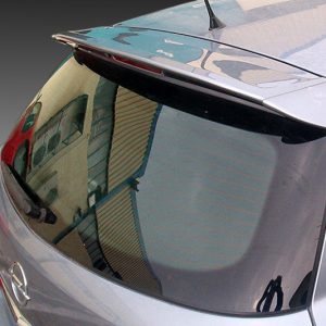 Close-up of the rear of a silver hatchback, showing the curved rear window and spoiler with reflections of a building in the glass.