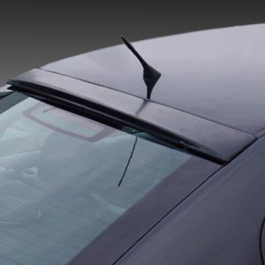 Close-up of a dark car's roof and rear window with a small shark-fin antenna on top and defroster lines in the rear window.