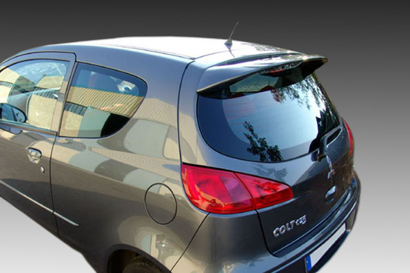 A-287_1jpg - OPSHOLDERS Rear-right view of a silver Mitsubishi Colt hatchback, showing the taillights and rear window.”