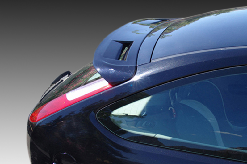 A-296_1jpg - OPSHOLDERS Close-up of the rear section of a blue car, showing the spoiler and curved rear window at an angle.