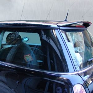 Close-up of a dark SUV with chrome trim and a roof spoiler, viewed from the side close to the front door area.