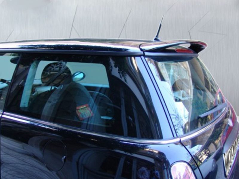 Close-up of a dark SUV with chrome trim and a roof spoiler, viewed from the side close to the front door area.
