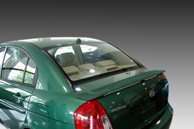 A-303_1jpg - OPSHOLDERS Green Hyundai sedan rear view with visible beige interior through rear window and taillights illuminated, parked indoors/near a gradient background.