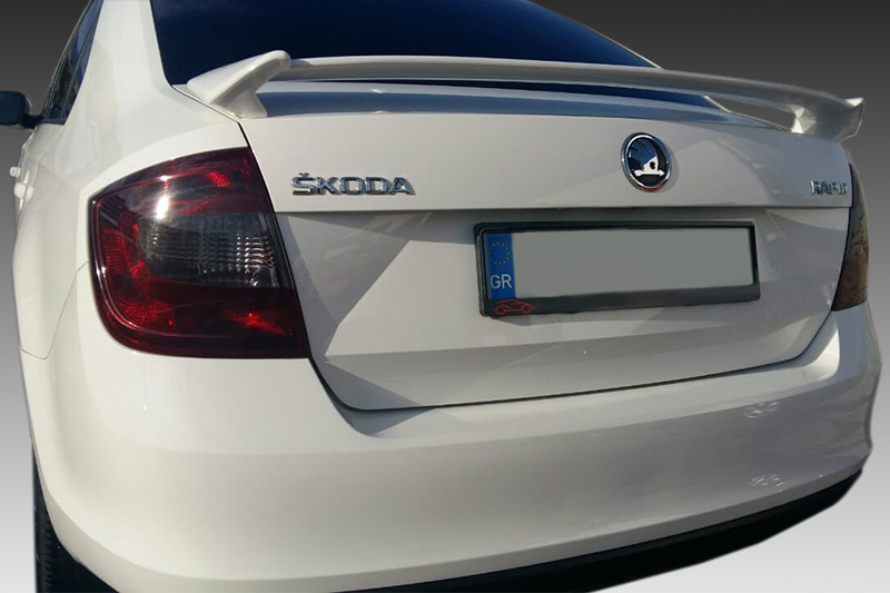 A-310_1-1jpg - OPSHOLDERS Rear view of a white Skoda Octavia, showing the trunk badges, tail light, and a European license plate.