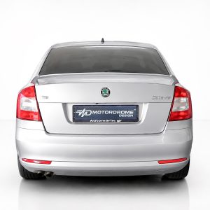 Rear view of a silver Skoda Octavia, showing taillights, rear bumper, and a blue Motordrome Design license plate center.