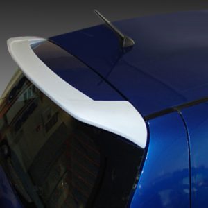 Blue hatchback car rear with a white spoiler mounted above the rear window, showing the curved tail design and antenna.