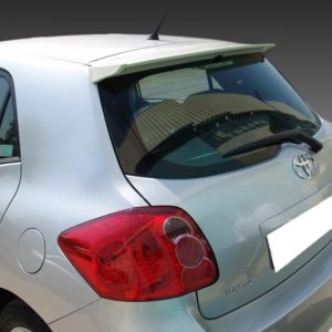 A-316_2jpg - OPSHOLDERS Silver hatchback viewed from the rear-right, showing Toyota logo and red taillights on a light-colored body.