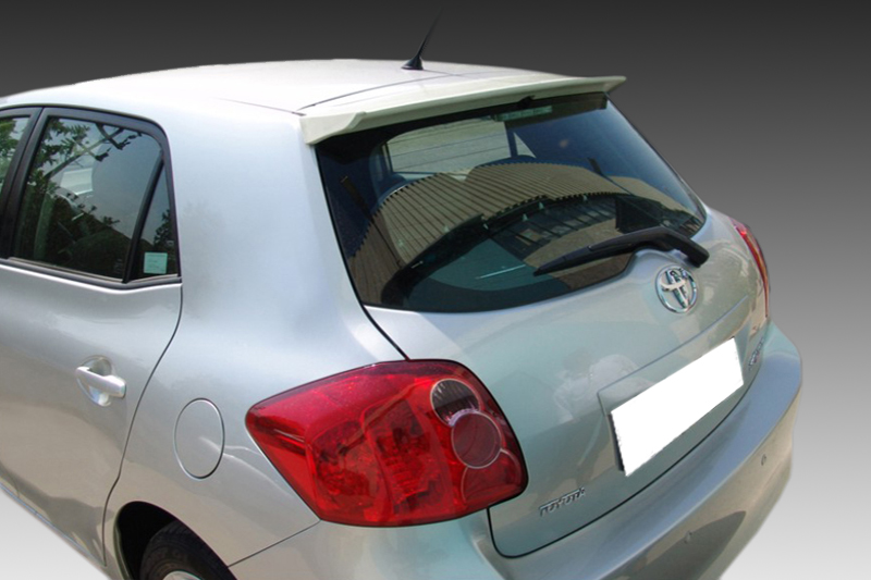 A-316_2jpg - OPSHOLDERS Silver hatchback viewed from the rear-right, showing Toyota logo and red taillights on a light-colored body.