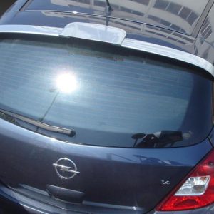 A-317_2jpg - OPSHOLDERS Rear view of a blue Opel Corsa hatchback photographed from above, showing the Opel emblem and rear window wiper.