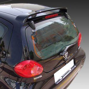 Rear view of a black Toyota hatchback showing red circular taillights, Toyota badge, and rear window with wiper.