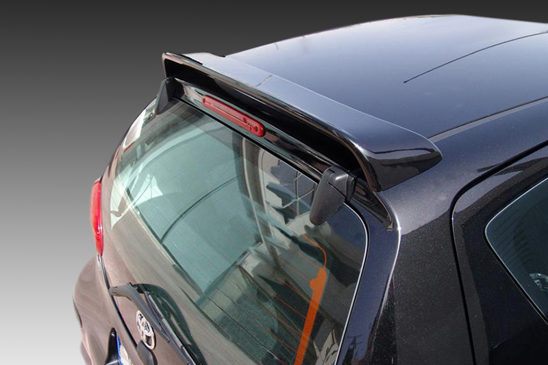 A-321_2jpg - OPSHOLDERS Rear three-quarters view of a dark blue hatchback with a roof spoiler and rear window wiper on the tailgate surface, viewed from above
