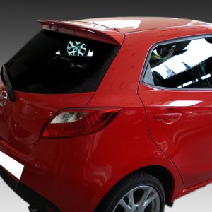 Rear-left view of a red hatchback with a dent on the rear door and visible wheel.