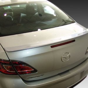 Rear view of a silver Mazda sedan showing taillights, trunk, and emblem in a showroom setting