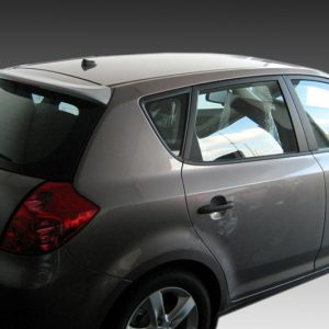 Silver hatchback car photographed from the rear-left side, showing taillights and rear window area. Alternative: A gray compact vehicle with its rear doors and window visible, seen from the side/angled view.